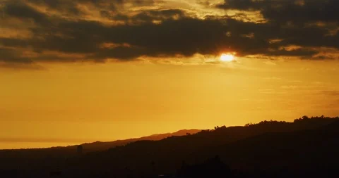 Slow motion of sunset in beautiful orange light in Los Angeles, California Stock Footage 115073034