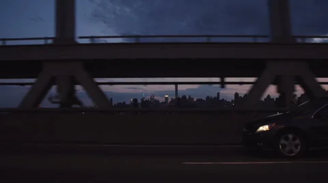 Slow motion sunset drive over the Triboro/RFK bridge in Queens, NY Stock Footage 63472827