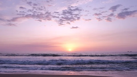 Slow motion sunset over ocean as bird flies overhead silhouetted against sky Stock Footage 115917592