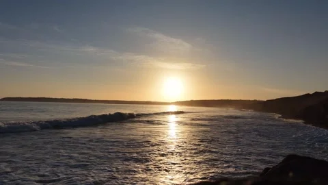 Slow Motion Sunset Over Ocean Waves Near Coastline in 4K Vídeos de archivo 332944073