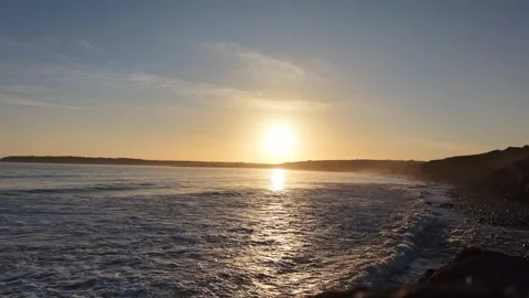 Slow Motion Sunset Over Ocean Waves Near Coastline in 4K Stock Footage 332944115