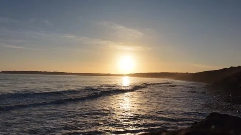 Slow Motion Sunset Over Ocean Waves Near Coastline in 4K 스톡 동영상 332944143
