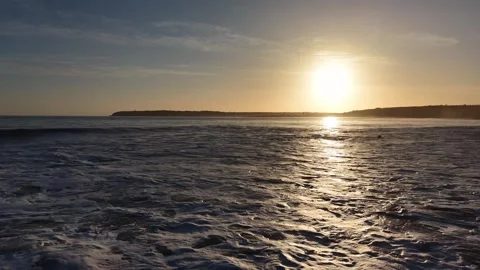 Slow Motion Sunset Over Ocean Waves Near Coastline in 4K Stock-Footage 332944362