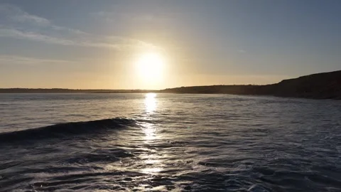 Slow Motion Sunset Over Ocean Waves Near Coastline in 4K Video stock 332944474
