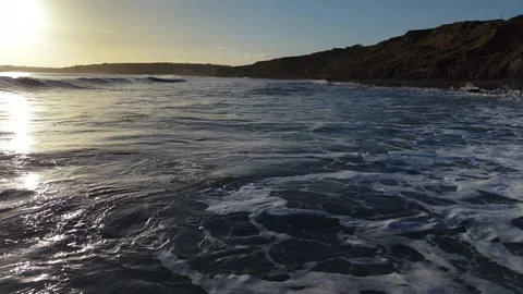 Slow Motion Sunset Over Ocean Waves Near Coastline in 4K 库存影片 332944645