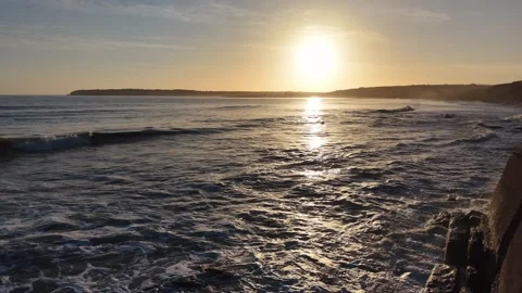 Slow Motion Sunset Over Sea With Rocky Coastline in 4K Stock Footage 332944365