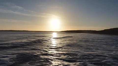 Slow Motion Sunset Over Sea With Waves and Coastal Silhouette Stock Footage 332944822