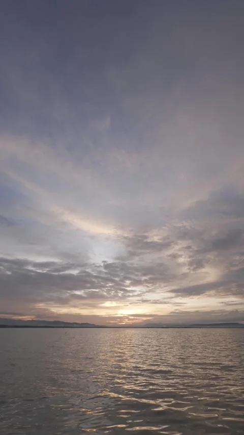 Slow Motion Sunset Over the Water with Clouds Stock Footage 311620422