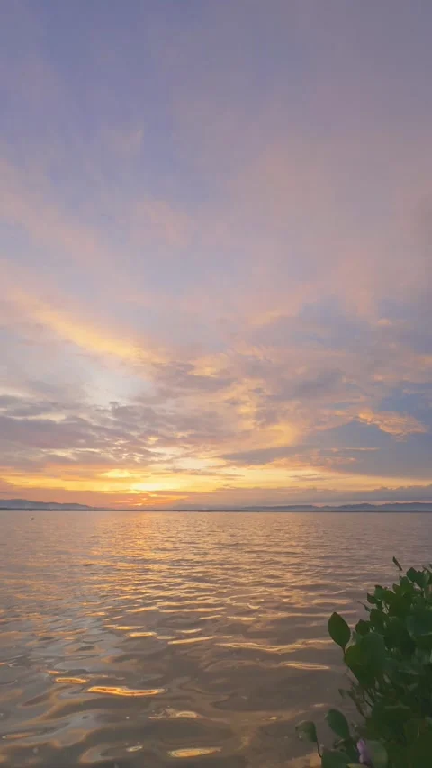 Slow Motion Sunset Over the Water with Clouds Stock Footage 311620449