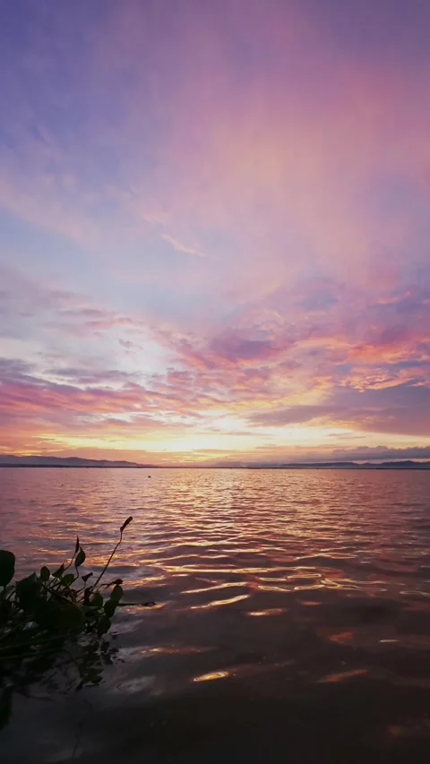 Slow Motion Sunset Over the Water with Clouds Stock Footage 311620518