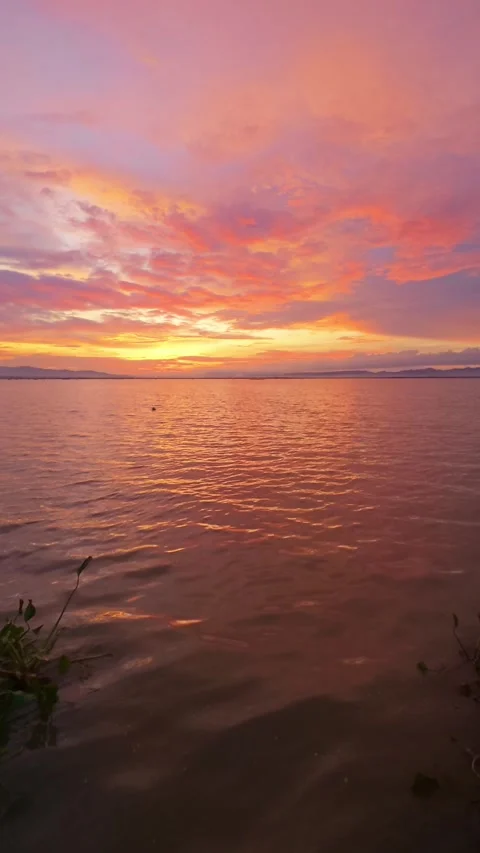 Slow Motion Sunset Over the Water with Clouds Stock Footage 311620520