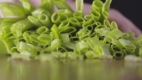 Slow motion of super sharp knife cutting chives, macro, selective focus Stock Footage 161248873