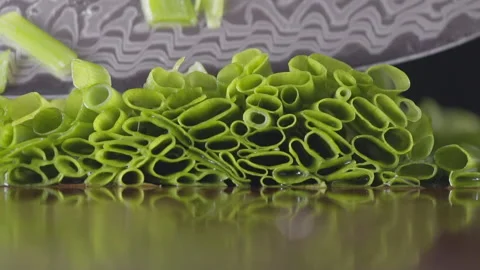 Slow motion of super sharp knife cutting chives, macro, selective focus Stock Footage 161248899