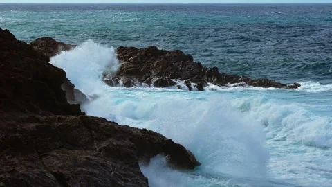 Slow motion surf spilling across volcanic shoreline Canary Islands Vídeo Stock 331080457
