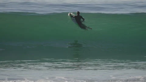 Slow motion of surfer floating over beautiful wave 4K Stock Footage 166756233