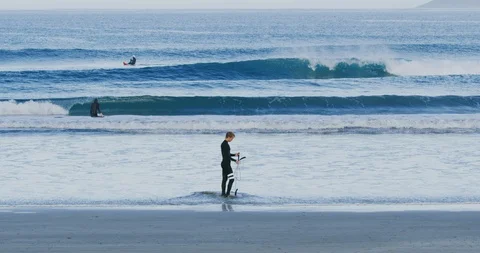 Slow motion of surfers in Morro Bay, Claifornia Stock Footage 99144164