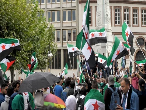Slow Motion of Syrian flags waving at protest in downtown Frankfurt Stock Footage 79711268