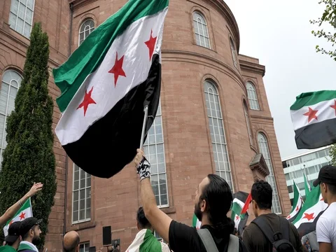 Slow Motion: Syrian protester waves national flag at a demonstration rally Stock Footage 79712563