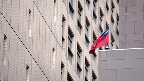 Slow motion of Taiwan flag on rooftop of city building Stock Footage 307571381