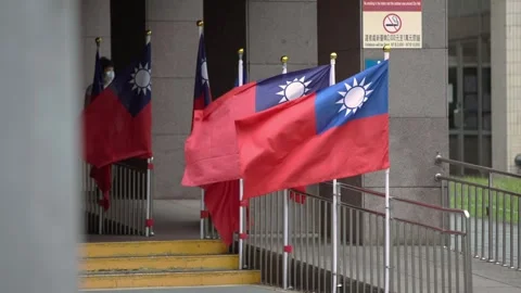 Slow motion of Taiwan flag waving beside modern building with green background Stock Footage 314017436