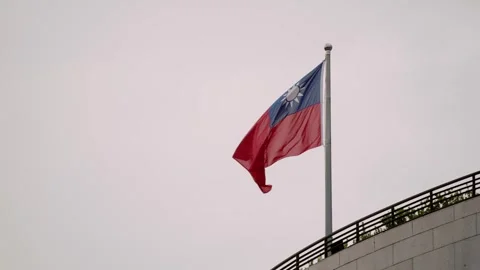 Slow motion of Taiwan flag waving atop a modern building Stock Footage 314233616