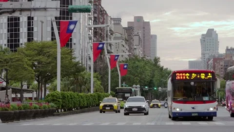 Slow motion of Taiwan flags with traffic and buildings background Stock Footage 313628001