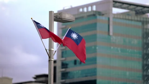 Slow motion of Taiwan flags waving against an urban backdrop, cityscape Stock Footage 313007873