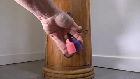 Slow motion – Taking candles from a small drawer. Stock Footage 119960626