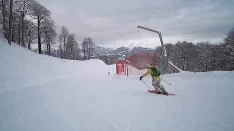 Slow motion of a talented skier rides down the hill. Female skier dressed in Stockbeeldmateriaal 101788095
