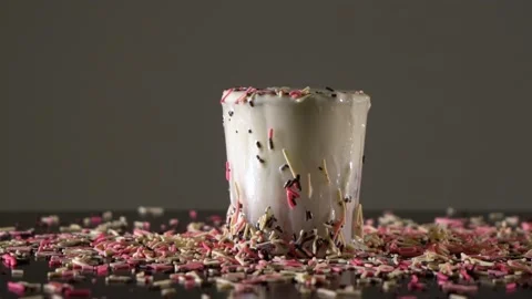 Slow motion of tasty confetti falling into glass of milk. 스톡 동영상 149896698
