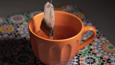 Slow motion tea bag dipped in hot water Stock Footage 111142378