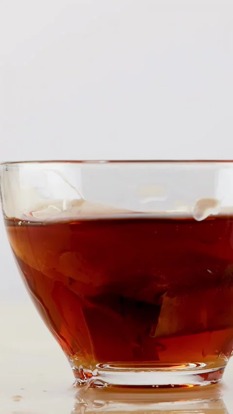 Slow Motion Tea Bag Splash in Clear Glass Cup Stock Footage 342579621