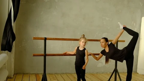 Slow motion teacher of classical dance teaches some steps to his young student Video stock 119387137