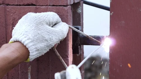 Slow-motion, Technicians are welding of steel fencing home Stock Footage 106434378