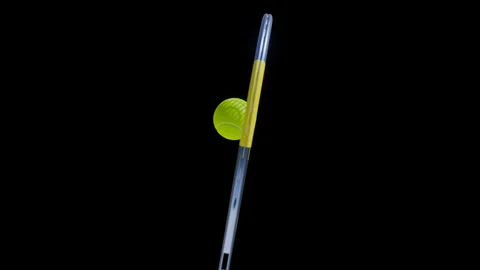 Slow motion of tennis racket hitting a ball on black background. 4K UHD Stock-Footage 240628976