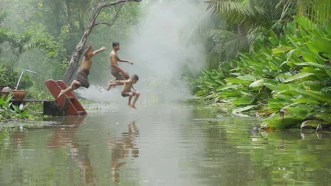 Slow motion of Thai children jumping in canal or river. Happiness young kids. Stock Footage 142652176