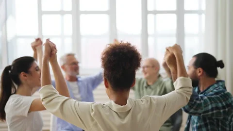 Slow-motion of therapy group joining their hands, coping with problems together Stock Footage 232296613
