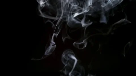 SLOW MOTION: Thin cigarette smoke lifts up on a dark background Stock Footage 70408727