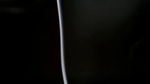 SLOW MOTION: Thin line and curl of smoke on a black background Stock Footage 70408662