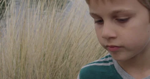 Slow Motion Thinking Young Boy Turns From One Side to the Other Stock Footage 61523745