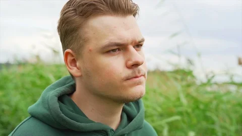 Slow motion of A thoughtful and sad young man who is staring away from camera Stock Footage 91230839