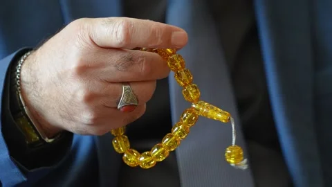Slow Motion of a Thoughtful Businessman Sorting Rosary 스톡 동영상 241708671