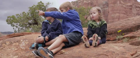 Slow Motion Three Children Enjoy the View from a Large Boulder Stock Footage 61837644