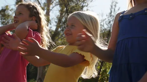 Slow motion of three children playing with bubbles in park. Stock Footage 43673312