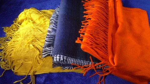 Slow motion – Three folded scarves thrown onto bed. Video stock 106386470
