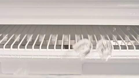 Slow motion of three ice cubes falling down from professional ice machine Stock Footage 154604218