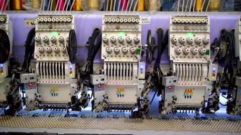 Slow motion three shot of automatic embroidery machine with multiple heads i Stock Footage 199272608