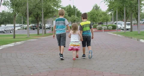 Slow Motion Three Siblings Walking Away on a Path Video stock 61651808