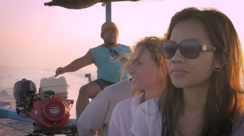 Slow motion of three tourists on a sightseeing boat tour in Bali Stock Footage 57102090