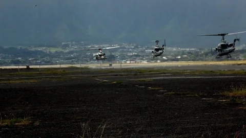 Slow Motion of Three U.S. Marine Helicopters Taking Off Stock Footage 128552124